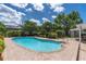 Backyard pool with brick pavers and lush landscaping offers a private oasis at 10611 131St St, Largo, FL 33774