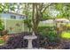 Ornate birdbath nestled among vibrant plants, enhancing the garden's tranquility and aesthetic appeal at 10611 131St St, Largo, FL 33774