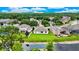 An aerial view showing the home's backyard, picturesque pond, and its place within the wider residential community at 10621 Ribbon Fern Way Way, Land O Lakes, FL 34638