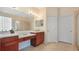 Well-lit bathroom featuring double sinks, vanity area, and ample cabinet space at 10621 Ribbon Fern Way Way, Land O Lakes, FL 34638