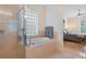 Bright bathroom with glass shower and large soaking tub and glass block window at 10621 Ribbon Fern Way Way, Land O Lakes, FL 34638