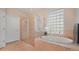 Luxurious bathroom featuring a soaking tub, glass shower, and natural light from a glass block window at 10621 Ribbon Fern Way Way, Land O Lakes, FL 34638