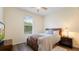 Inviting bedroom with a comfortable queen bed and bright natural light from the windows at 10621 Ribbon Fern Way Way, Land O Lakes, FL 34638