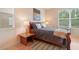 Bright bedroom with natural light, a queen bed, and a view of the outdoors at 10621 Ribbon Fern Way Way, Land O Lakes, FL 34638