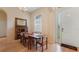 Dining room featuring a wooden table, arched window, and decorative front door at 10621 Ribbon Fern Way Way, Land O Lakes, FL 34638