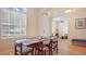 Bright dining room featuring hardwood floors, a large window, and seating for six at 10621 Ribbon Fern Way Way, Land O Lakes, FL 34638