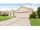 Charming single-story home with a well-manicured lawn and an attached two car garage at 10621 Ribbon Fern Way Way, Land O Lakes, FL 34638