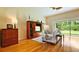 Bright living room with hardwood floors, stylish furnishings, and sliding glass doors to the outdoors at 10621 Ribbon Fern Way Way, Land O Lakes, FL 34638