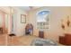 Bright living room featuring hardwood floors, a large window, and a plush patterned chaise lounge at 10621 Ribbon Fern Way Way, Land O Lakes, FL 34638