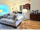 Spacious living area showcasing a comfortable sofa, kitchen access, and modern barstool seating at 10621 Ribbon Fern Way Way, Land O Lakes, FL 34638