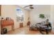 Cozy living room features a ceiling fan, a window with blinds, and a plush patterned chaise lounge at 10621 Ribbon Fern Way Way, Land O Lakes, FL 34638