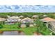 Expansive backyard view featuring a screened pool, lush landscaping, and a serene pond, perfect for outdoor living at 10734 Banfield Dr, Riverview, FL 33579