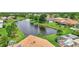 A serene water view enhances the landscape, complemented by lush greenery and beautiful residences, creating a peaceful neighborhood at 10734 Banfield Dr, Riverview, FL 33579