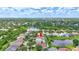 Aerial view of a home in a green community with a lake, pool, and mature trees at 10734 Banfield Dr, Riverview, FL 33579