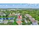 A scenic aerial view of a home nestled in a lush, green neighborhood with a tranquil lake nearby at 10734 Banfield Dr, Riverview, FL 33579