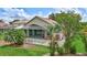 The backyard features lush lawn, a screened in patio, and lovely, mature landscaping at 10734 Banfield Dr, Riverview, FL 33579