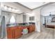 An elegant bathroom shows double sinks with cherry wood cabinets and new vinyl flooring that connects to the bedroom at 10734 Banfield Dr, Riverview, FL 33579