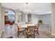 Formal dining room showcasing hardwood floors, chandelier lighting, views to kitchen and living areas through archways at 10734 Banfield Dr, Riverview, FL 33579