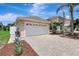 Home exterior showing the driveway leading to a two car garage and manicured front lawn with mulch at 10734 Banfield Dr, Riverview, FL 33579