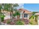 Well-maintained home showcasing a manicured lawn, mature landscaping, and architectural details at 10734 Banfield Dr, Riverview, FL 33579