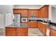 Contemporary kitchen with stainless steel appliances, wood cabinetry, granite countertops and hardwood floors at 10734 Banfield Dr, Riverview, FL 33579