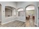 View of the living room with arches and light hardwood floors at 10734 Banfield Dr, Riverview, FL 33579