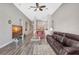 Inviting living room with vaulted ceilings, ceiling fan, and wood-look floors at 10734 Banfield Dr, Riverview, FL 33579