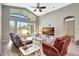 Living room with fan, sliding glass doors, and view of the pool area at 10734 Banfield Dr, Riverview, FL 33579