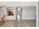 Open-concept living room featuring hardwood floors and arched openings that provide views into the kitchen and dining area at 10734 Banfield Dr, Riverview, FL 33579