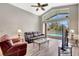 View of the living room with ceiling fan and sliding glass doors that leads to the pool area at 10734 Banfield Dr, Riverview, FL 33579