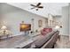 Spacious living room with hardwood floors, ceiling fan, and view to the kitchen at 10734 Banfield Dr, Riverview, FL 33579