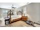 A cozy bedroom features a four-poster bed, a ceiling fan and stylish decor, creating a relaxing retreat at 10734 Banfield Dr, Riverview, FL 33579