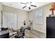 Practical home office featuring a ceiling fan, window shutters, laminate flooring and functional layout at 10734 Banfield Dr, Riverview, FL 33579