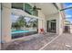 Spacious patio with views of the screened-in pool and backyard, accessible through sliding glass doors at 10734 Banfield Dr, Riverview, FL 33579