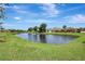 Scenic pond view showcases lush green landscaping and surrounding homes in a serene community setting at 10734 Banfield Dr, Riverview, FL 33579