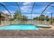 Refreshing pool and spa surrounded by a screened enclosure, offering a private and relaxing backyard oasis at 10734 Banfield Dr, Riverview, FL 33579