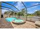 Sparkling pool and spa area enclosed with screen, complemented by a serene view of the water and landscaping at 10734 Banfield Dr, Riverview, FL 33579