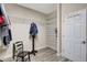 A spacious walk-in closet offers lots of storage shelving, hanging space, and laminate flooring at 10734 Banfield Dr, Riverview, FL 33579