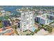 Great aerial view of a modern condo featuring a pool, lush landscaping, and serene waterfront living at 11000 Gulf Blvd # 703, Treasure Island, FL 33706