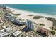 Aerial view of beach condo building with lush sandy beach and beautiful view of the Gulf of Mexico at 11000 Gulf Blvd # 703, Treasure Island, FL 33706