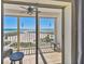 Stunning balcony with amazing ocean views, comfortable seating, and cool tile flooring at 11000 Gulf Blvd # 703, Treasure Island, FL 33706