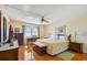 Bright and airy bedroom features hard wood floors, ceiling fan and view of the beach from the window at 11000 Gulf Blvd # 703, Treasure Island, FL 33706