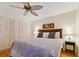 Charming bedroom with hardwood floors, ceiling fan, and generous closet space for convenient storage at 11000 Gulf Blvd # 703, Treasure Island, FL 33706