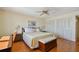 Cozy bedroom with a comfortable bed, ceiling fan, closet and warm hardwood floors throughout at 11000 Gulf Blvd # 703, Treasure Island, FL 33706