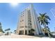 Upward angle showcasing a modern condo with balconies, parking, and a vibrant street view at 11000 Gulf Blvd # 703, Treasure Island, FL 33706