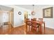 Inviting dining area with wood floors, a stylish light fixture, and seating for four at 11000 Gulf Blvd # 703, Treasure Island, FL 33706
