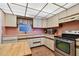 Functional kitchen with stainless steel appliances, tile floors, and ample counter space at 11000 Gulf Blvd # 703, Treasure Island, FL 33706