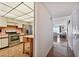 View of kitchen and entry to living room with wood floors, appliances, and beach view at 11000 Gulf Blvd # 703, Treasure Island, FL 33706