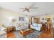 Bright living room featuring hardwood floors, ceiling fan, and stylish furniture at 11000 Gulf Blvd # 703, Treasure Island, FL 33706