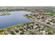 An aerial view captures a lakeside community with lush landscaping and an expansive lake, providing a picturesque setting at 11603 Heron Watch Pl, Riverview, FL 33569